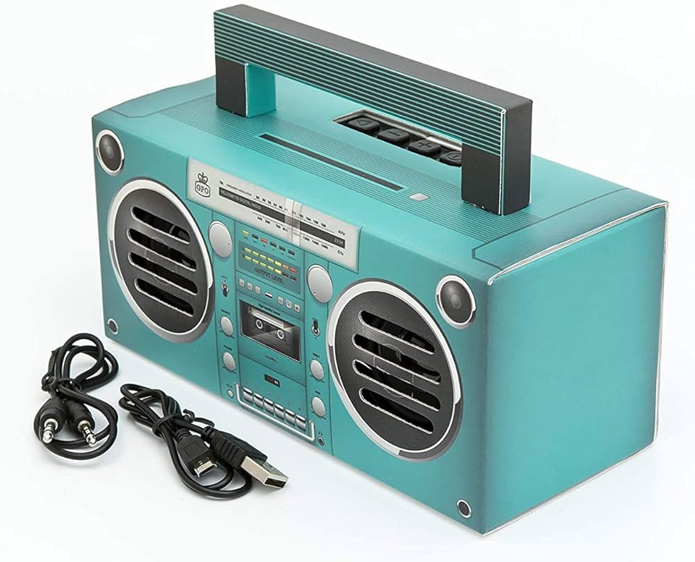 a modern turquoise boombox with cassette player and assorted cables.