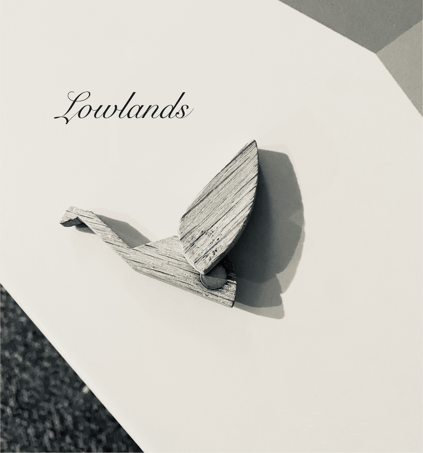 An origami-style bird on a beige background, with the caption "Lowlands" in script