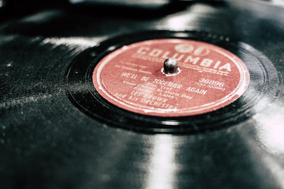 close-up photograph of a black vinyl record with a red center label that reads "Columbia" in gold print.