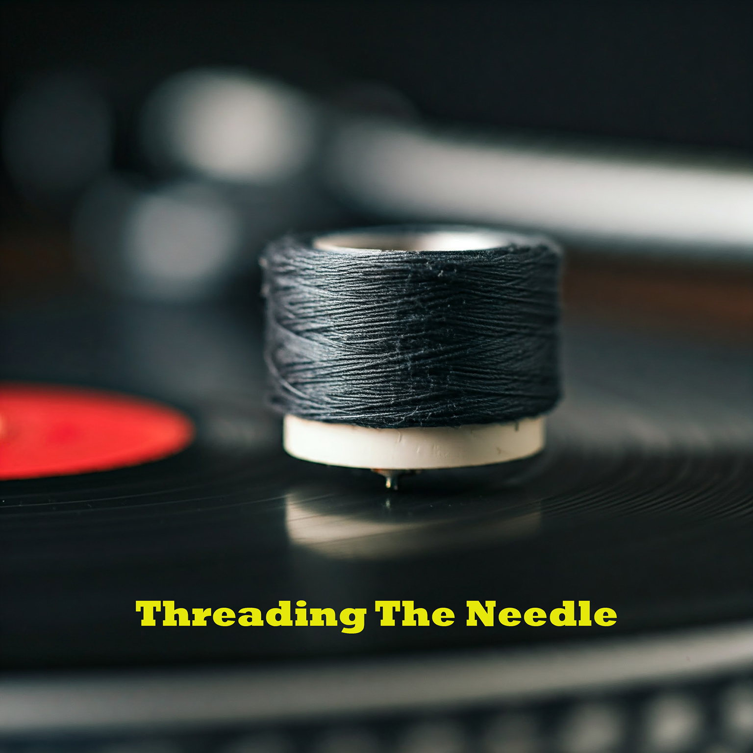 image: a spool of black thread sitting atop a vinyl record with a red center label; caption reads "Threading The Needle" in yellow print