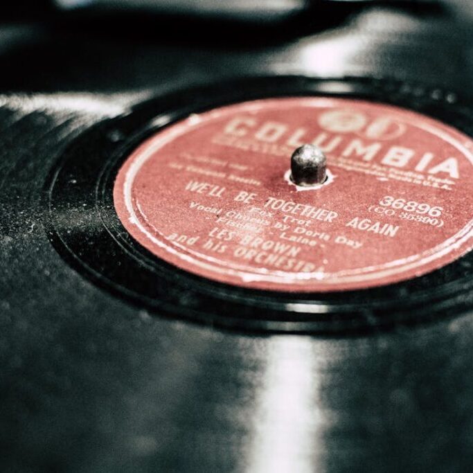 close-up photograph of a black vinyl record with a red center label that reads "Columbia" in gold print.